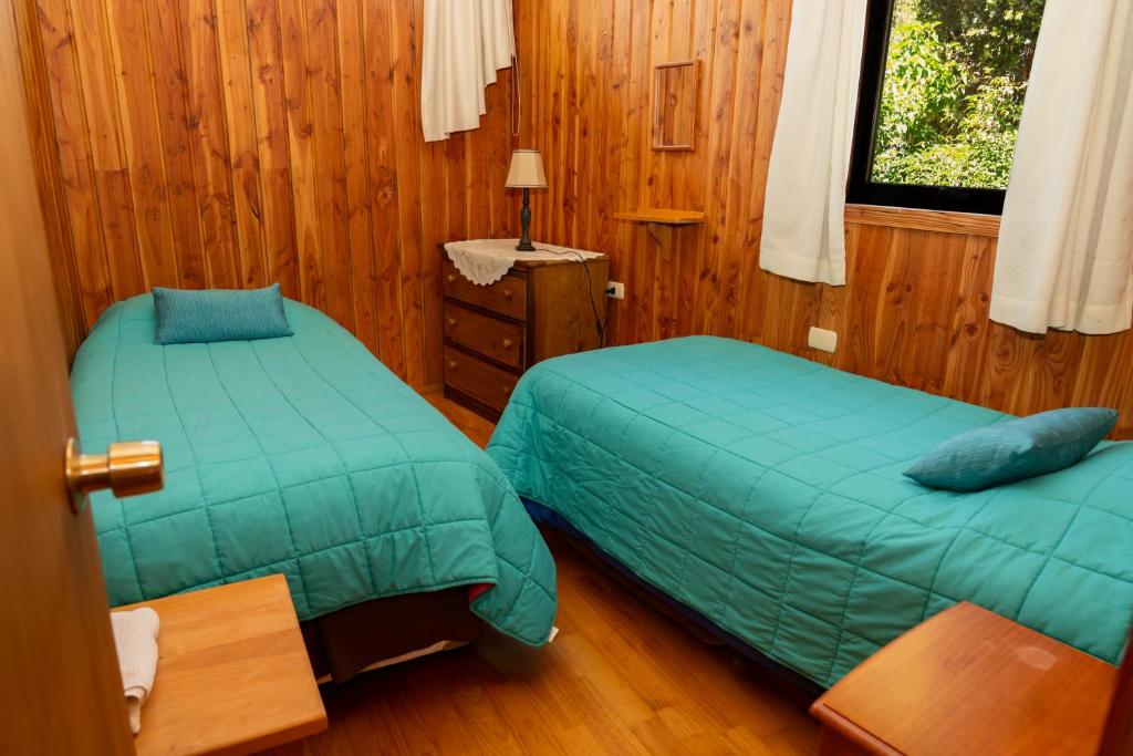 Postel nebo postele na pokoji v ubytování Cabañas Entre Verdes