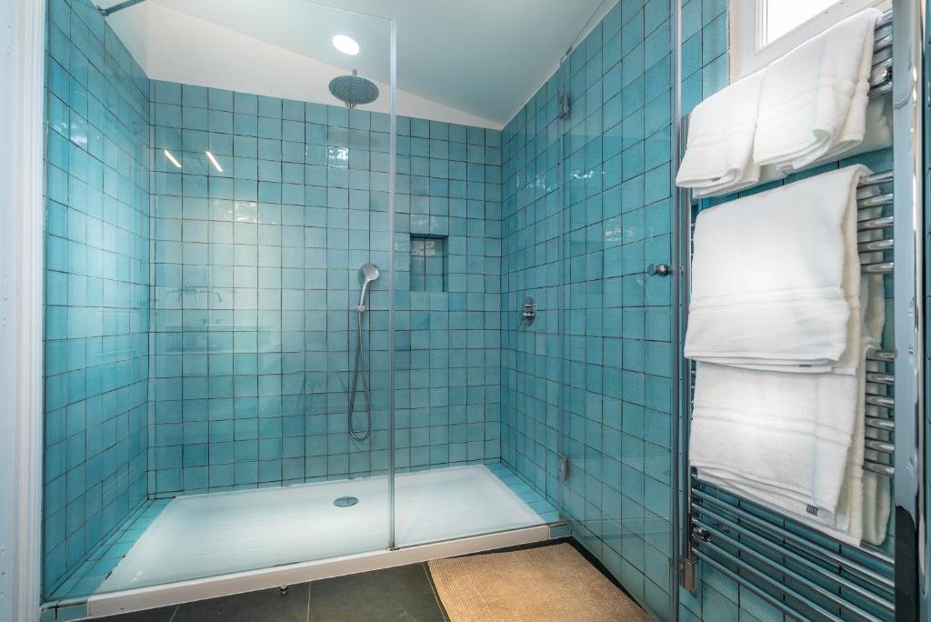 a bathroom with a shower with blue tiles at Villa Vasco da Gama in Cascais