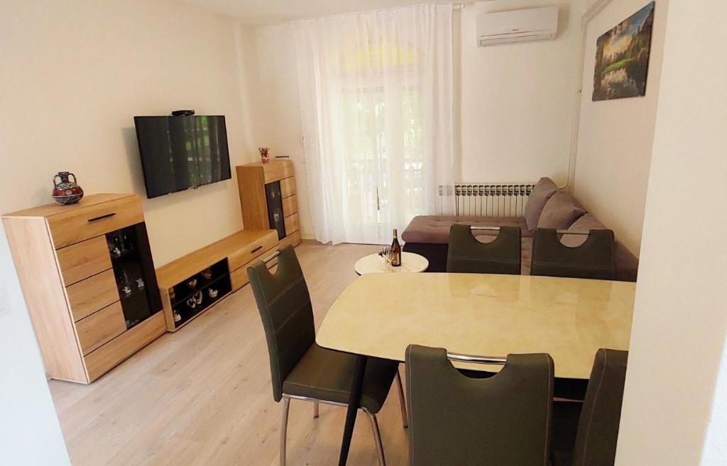 a living room with a dining room table and a couch at Kuća za odmor Dado in Jelenje