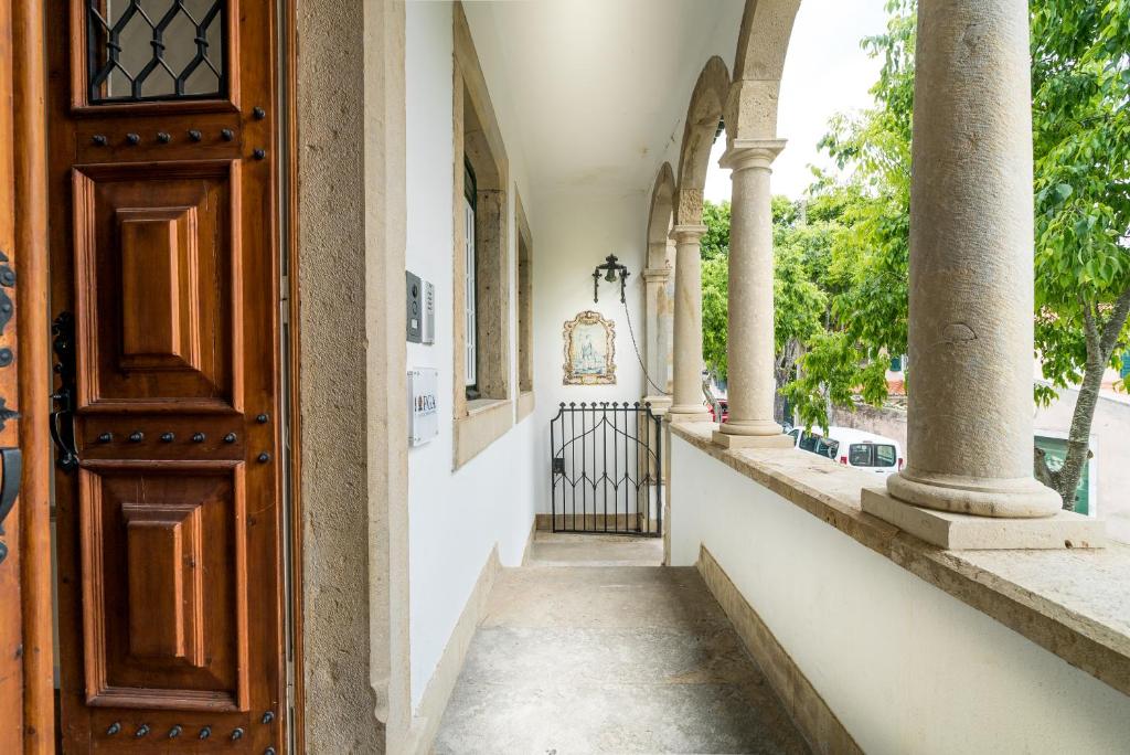 an entrance to a building with columns and a door at Villa Vasco da Gama in Cascais