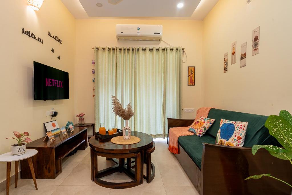 a living room with a couch and a table at Siolim by nidra stays in Siolim