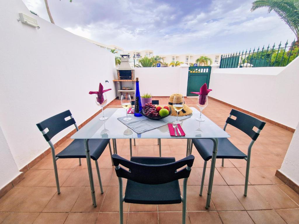 a dining table and chairs on a balcony with a view at Casa Triana in Costa Teguise