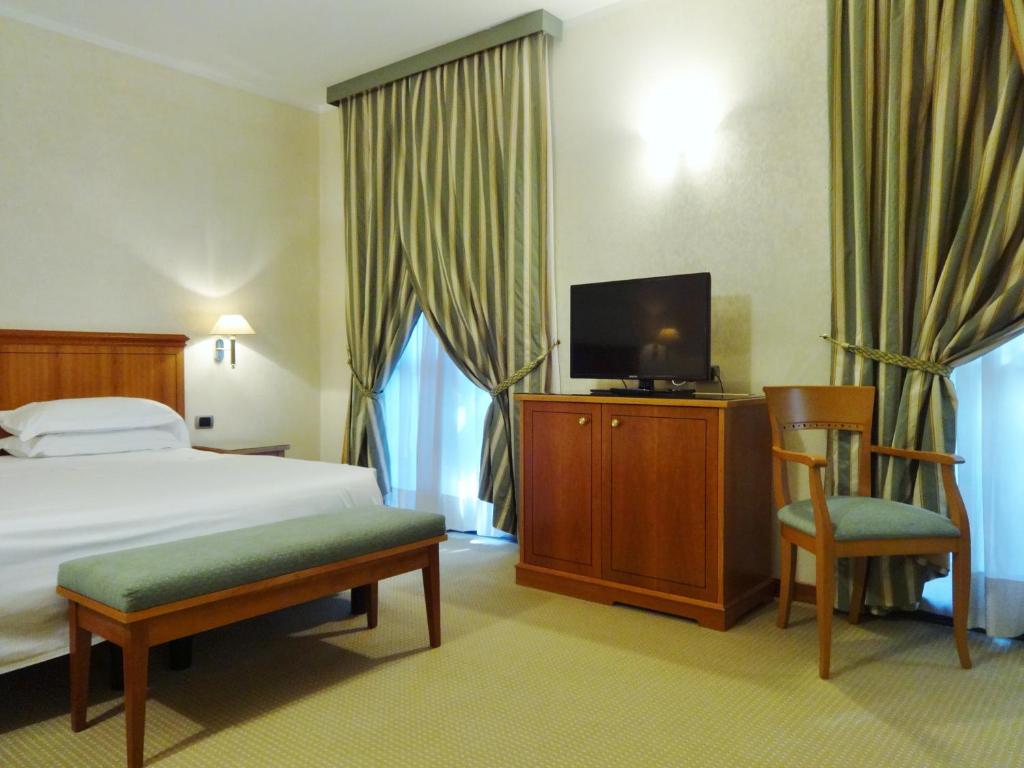 Posteľ alebo postele v izbe v ubytovaní Hotel Excelsior Magenta