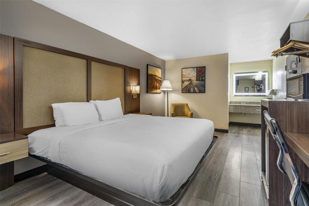 a hotel room with a large bed and a kitchen at Best Western Salisbury Plaza in Salisbury