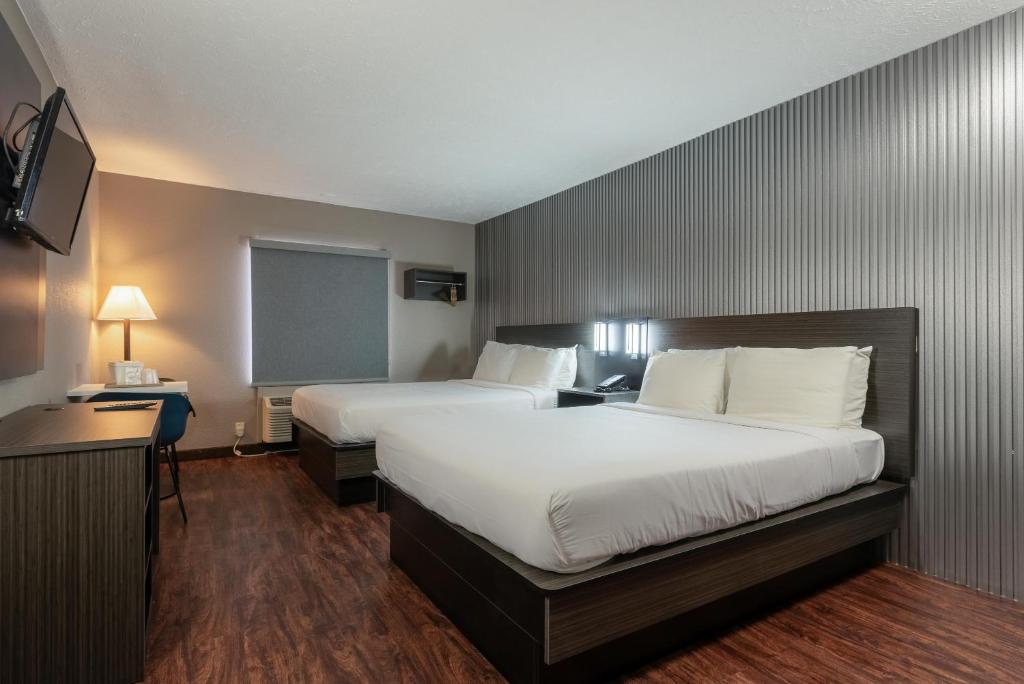 a hotel room with two beds and a television at Studio 6 Limon, CO I 70 in Limon