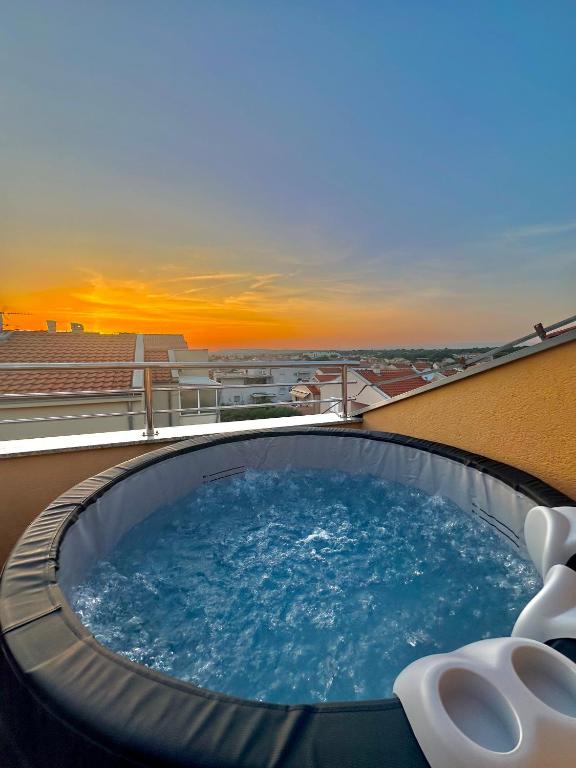 a hot tub on the roof of a building at Apartman Maky in Biograd na Moru
