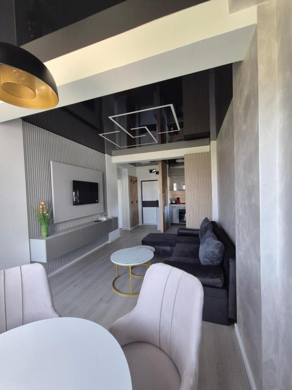 a living room with a couch and a table at The Black Sea Vibe Retreat in Năvodari