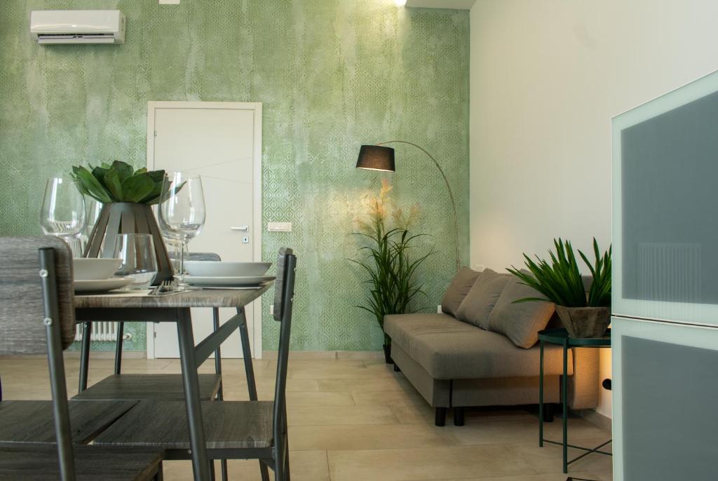 a dining room with a table and a couch at LOFT500 - Maranello - Ferrari, Design and Comfort in San Venanzio