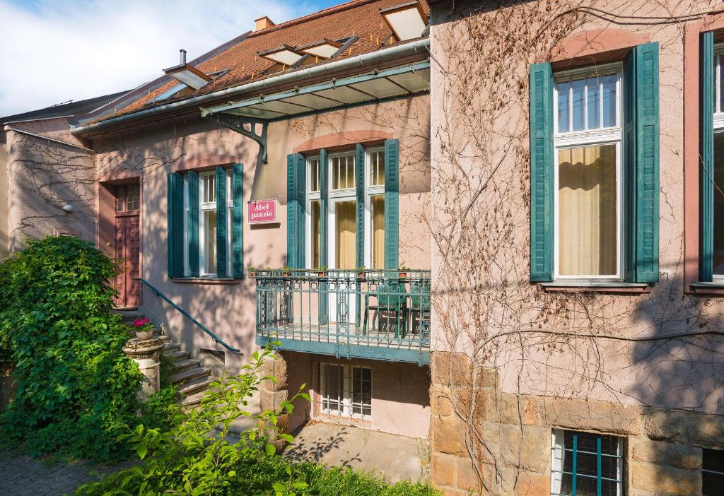 a building with a balcony on the side of it at Hotel Abel Pension Budapest in Budapest