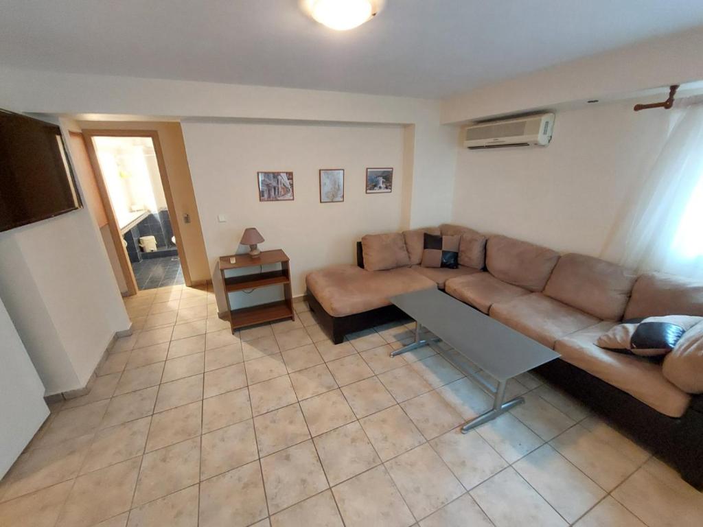 a living room with a couch and a table at Crab's Original Apartment 1 in Vrontados