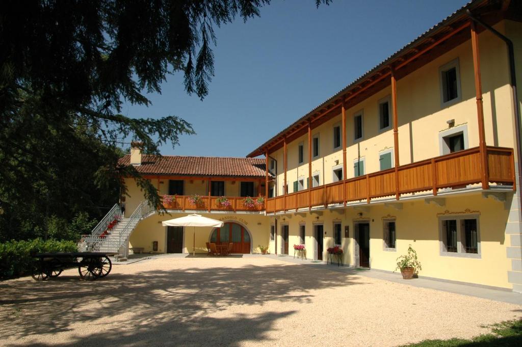 a large building with a staircase next to it at Country House Ramandolo Club in Nimis