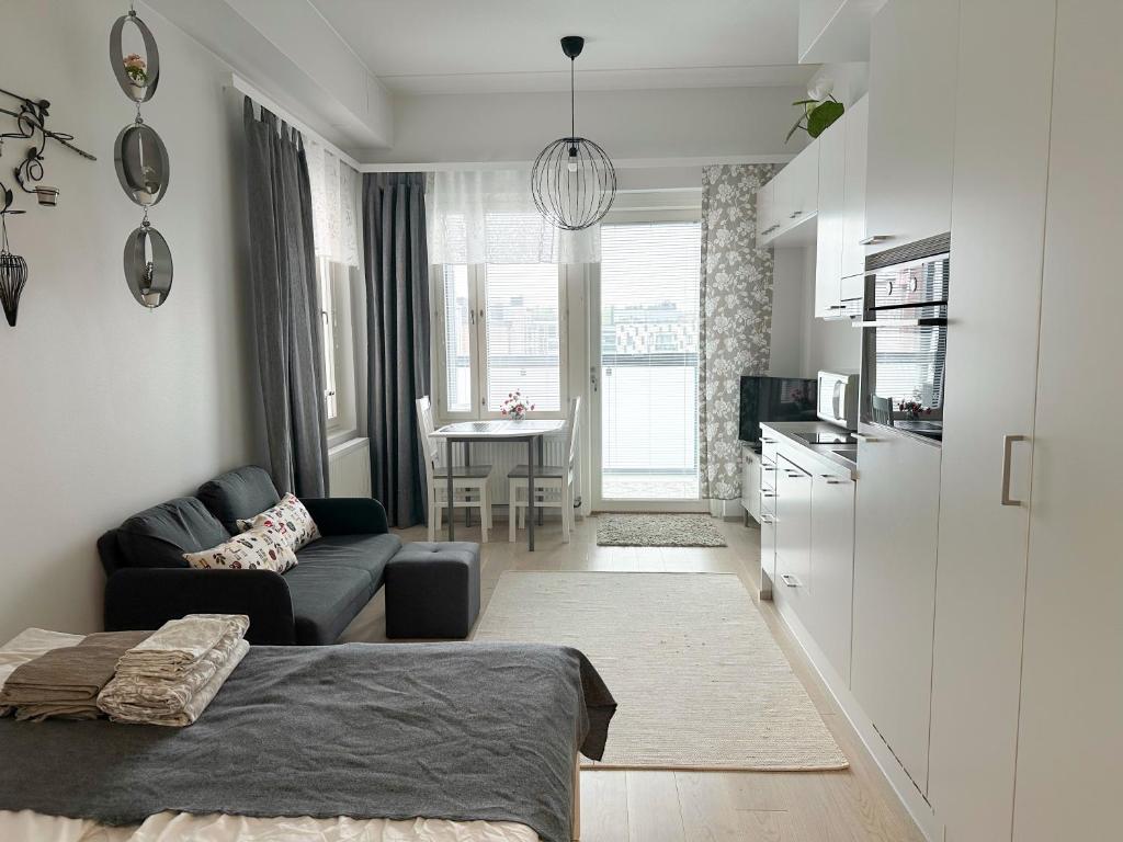 a small living room with a couch and a table at Apartment Kruuna in Kuopio