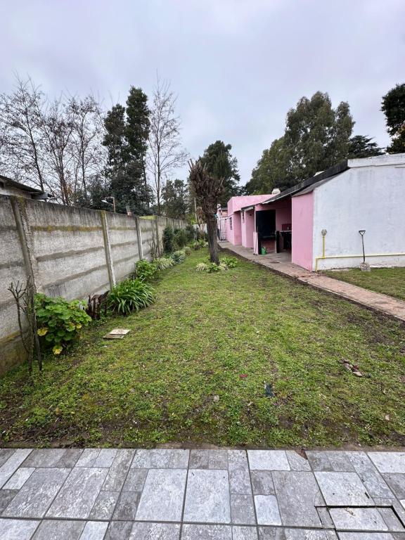an empty yard next to a fence with a tree at Hospedaje La Terminal in La Porteña