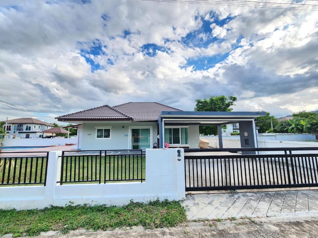 a white house with a gate and a fence at Pool Villa - Phetchabun in Ban Yawi
