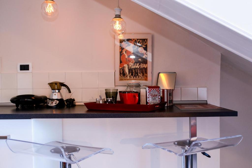 a kitchen with a counter with two faucets at Stylish Loft Gioia in Turin