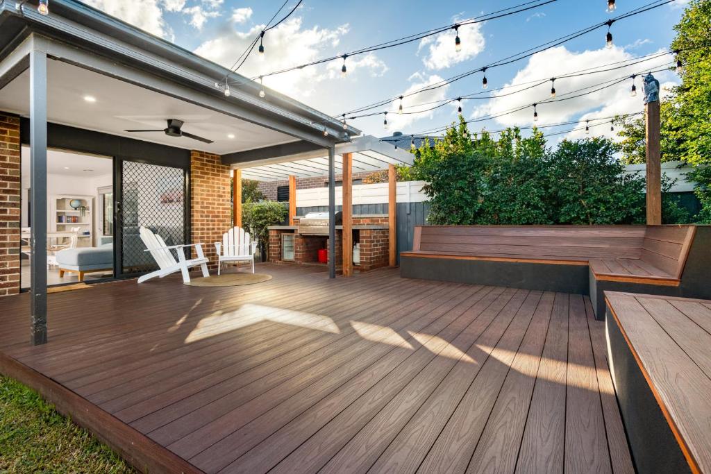 a deck with a table and chairs on a house at Family-Friendly 4BR Mount Duneed Manor in Mount Duneed