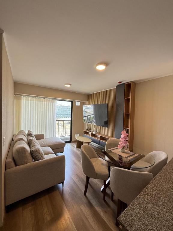 a living room with a couch and chairs and a table at Apartment in La Victoria in Lima