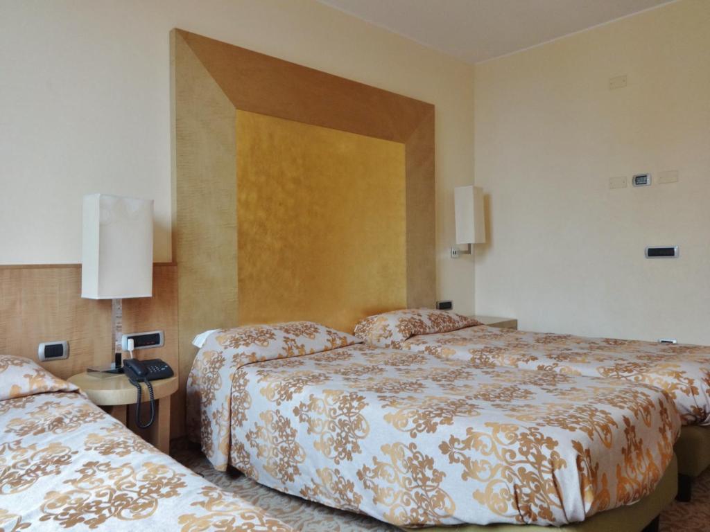 Posteľ alebo postele v izbe v ubytovaní Hotel Tiffany Milano