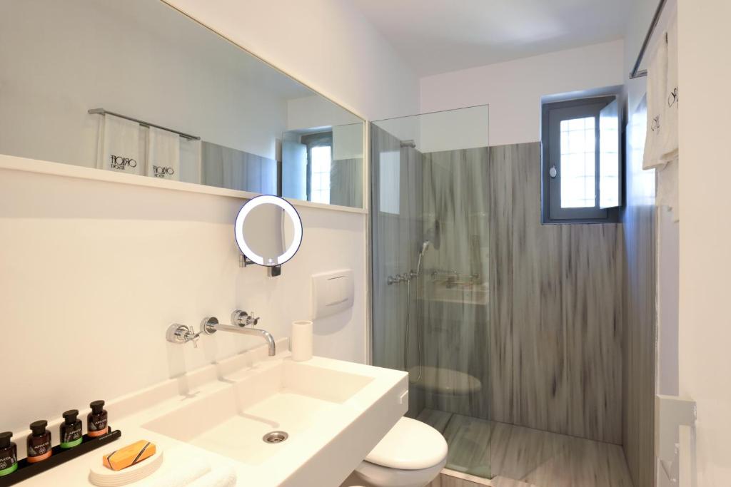 a bathroom with a sink and a toilet and a shower at Orloff Resort in Spetses