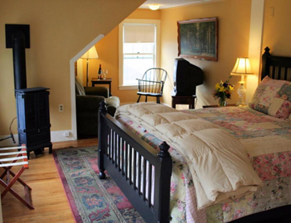 a bedroom with a large bed and a living room at Wildcat Inn and Tavern in Jackson