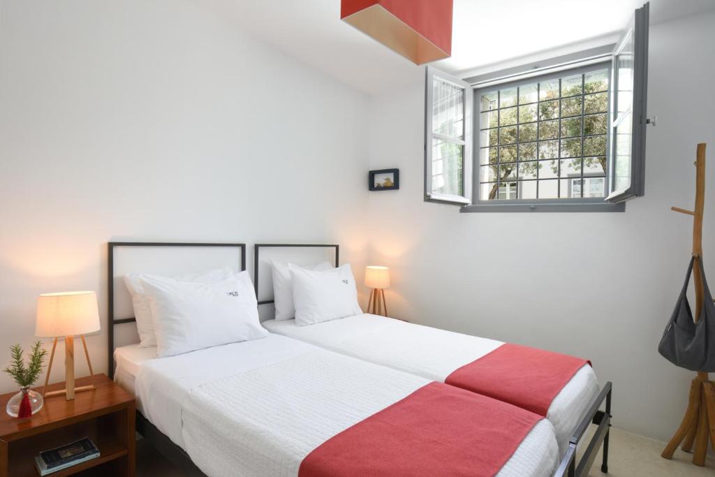 a bedroom with two beds and a window at Orloff Resort in Spetses