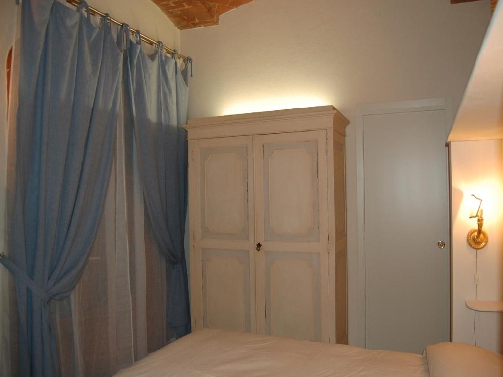 Postel nebo postele na pokoji v ubytování Monolocale a Buonconvento