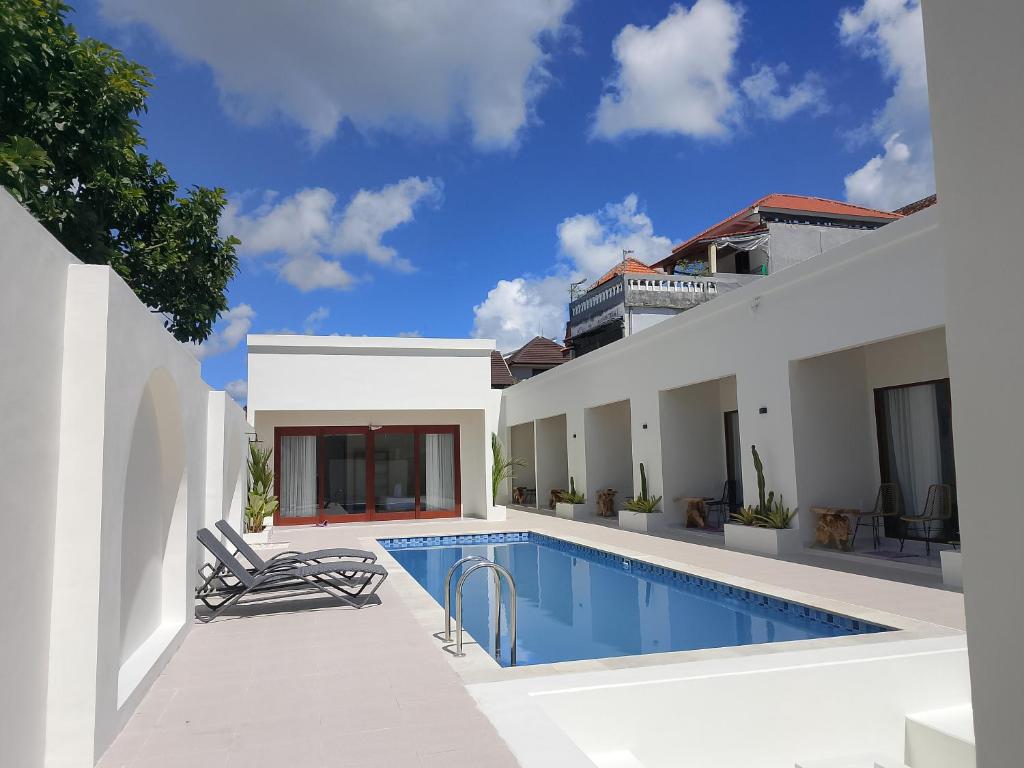 a swimming pool in the backyard of a house at Apartemen JIRO BALI in Ngurah Rai International Airport