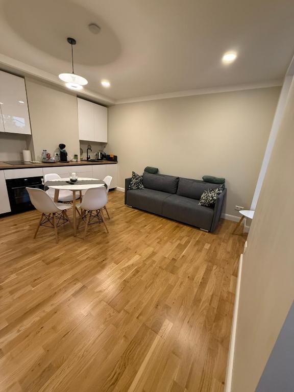 a living room with a couch and a table at Pine cone cozy apartment in Riga