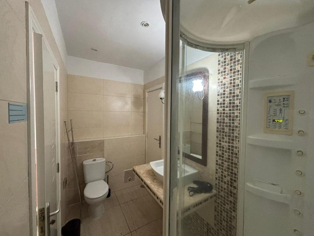 a bathroom with a toilet and a sink and a shower at Exclusive Master Apartment in Adeje