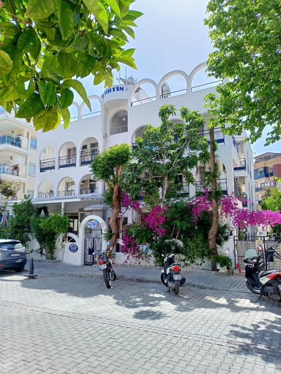 a building with motorcycles parked in front of it at Villa Fortin Pension in Kuşadası