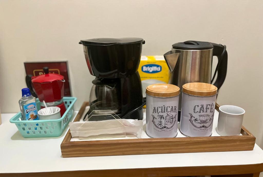a tray with a coffee maker and cups on a counter at Studio no Largo da Carioca - Rio de Janeiro in Rio de Janeiro