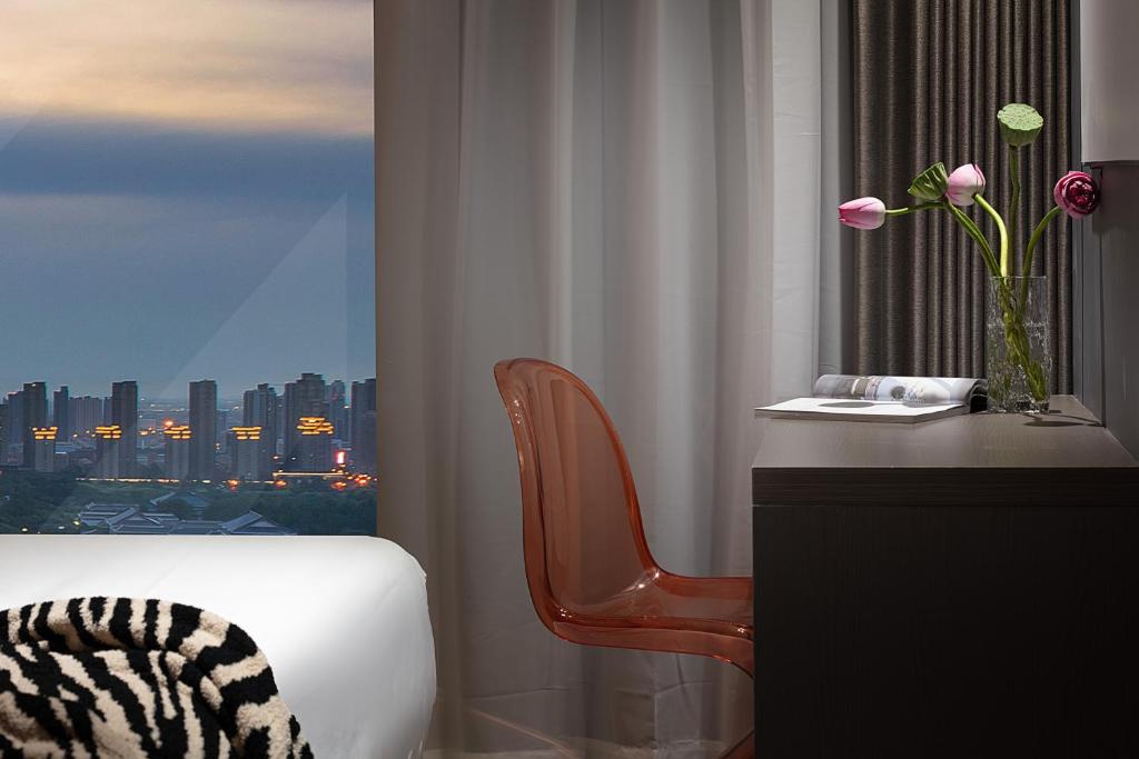 Postel nebo postele na pokoji v ubytování Enji M Hotel-Xi’an datangbuyecheng