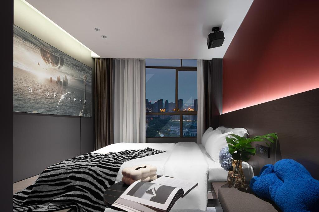 Postel nebo postele na pokoji v ubytování Enji M Hotel-Xi’an datangbuyecheng