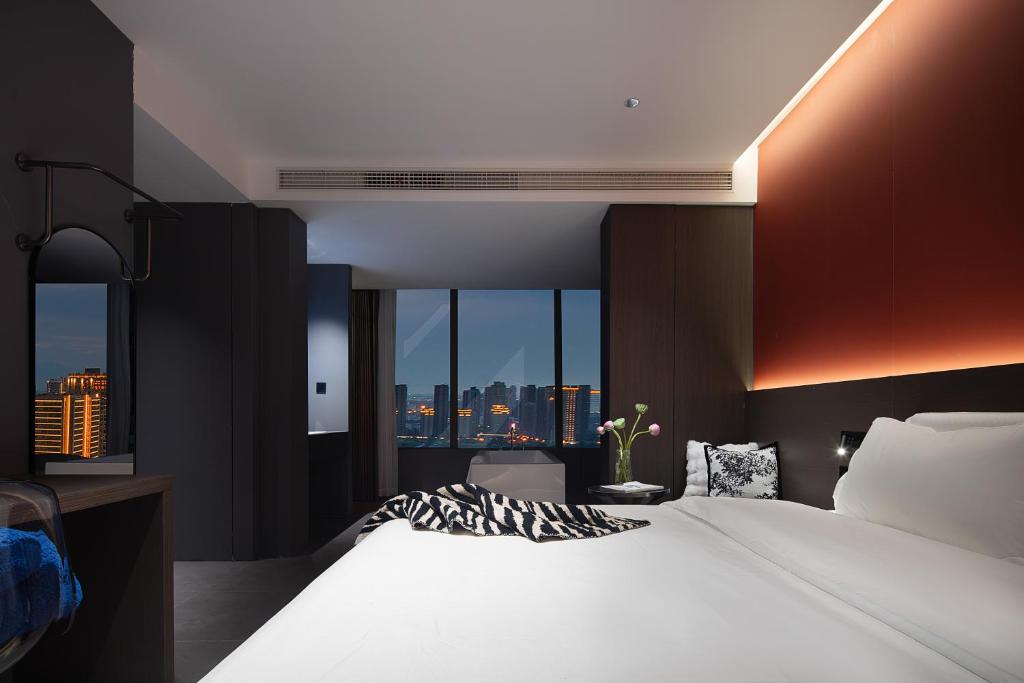 Postel nebo postele na pokoji v ubytování Enji M Hotel-Xi’an datangbuyecheng