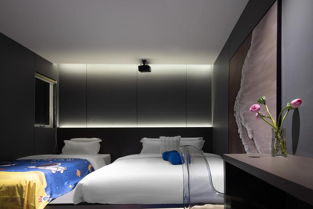 Postel nebo postele na pokoji v ubytování Enji M Hotel-Xi’an datangbuyecheng