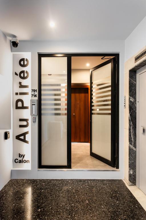 a pivot door in a room with a entrance at Au Piree by Calon in Piraeus