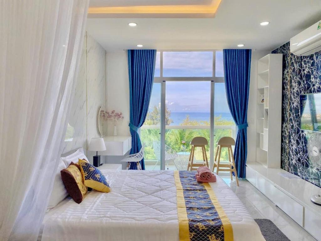 a bedroom with a bed and a large window at Ocean Vista Mai House in Ấp Phú Tịnh (2)