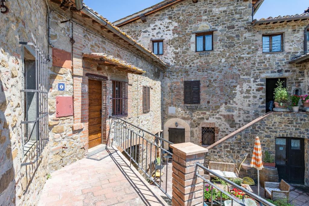 a stone building with a staircase in front of it at Romantic Apartment In Chianti Classico - Happy Rentals in Castelnuovo Berardenga