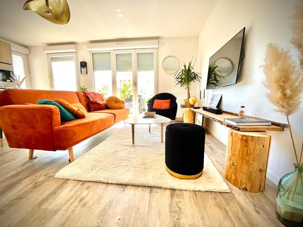 a living room with a couch and a table at New apartment near Paris in Bezons