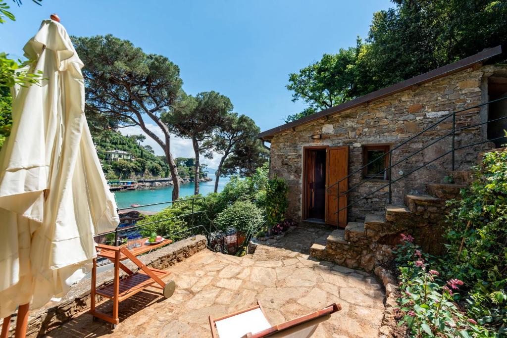 a patio with an umbrella and a building at Portofino Sea View Home in Paraggi in Portofino