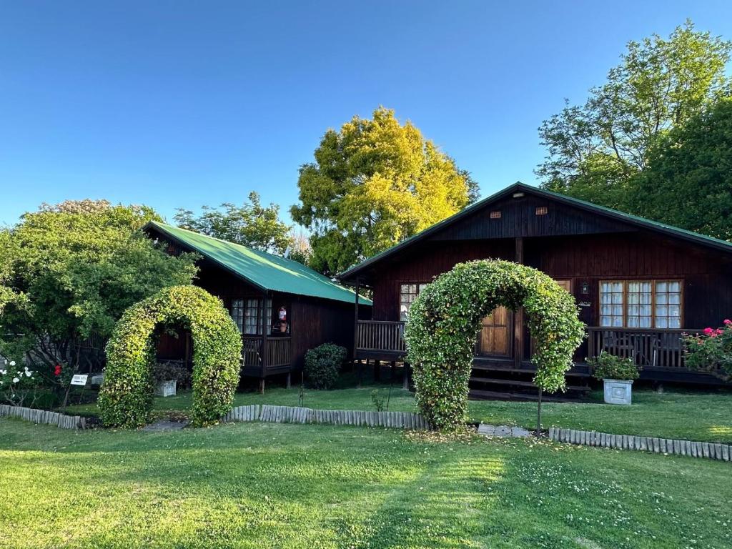 a house with a hedge in front of it at Thyme and Again B&B Estcourt in Estcourt