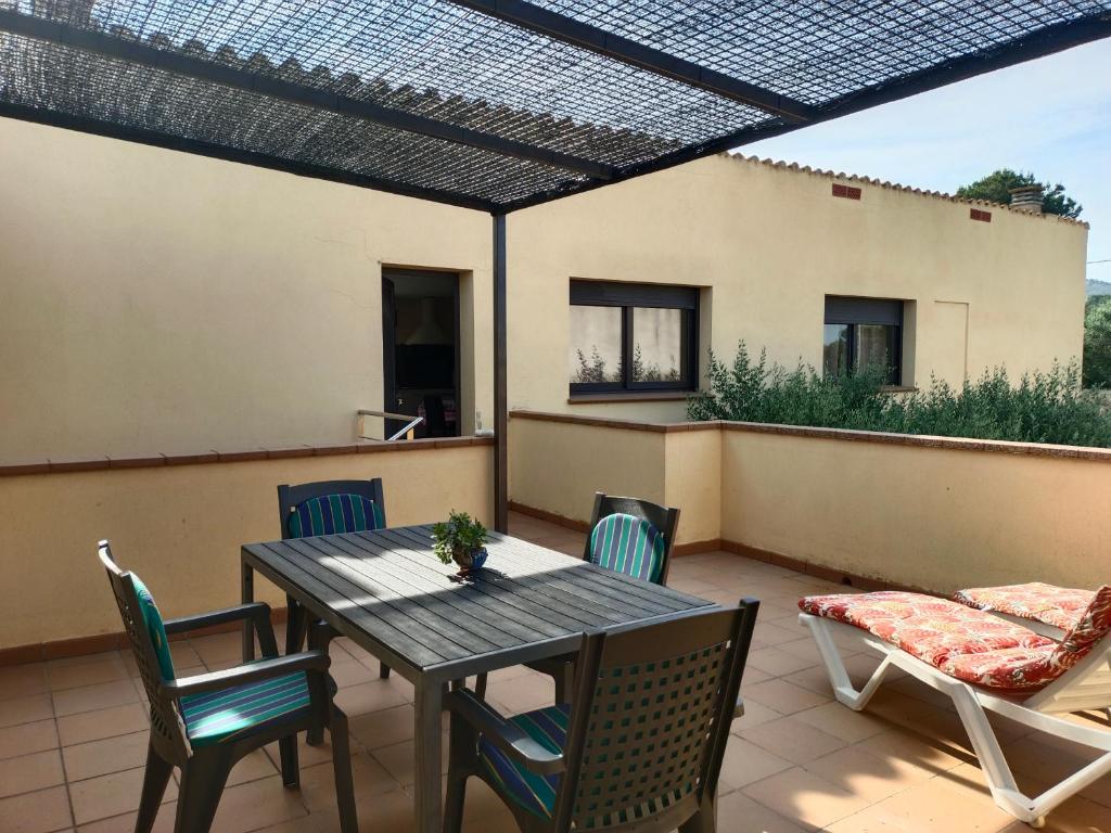 a patio with a table and chairs and a couch at La Pallissa 9 in Torroella de Montgrí