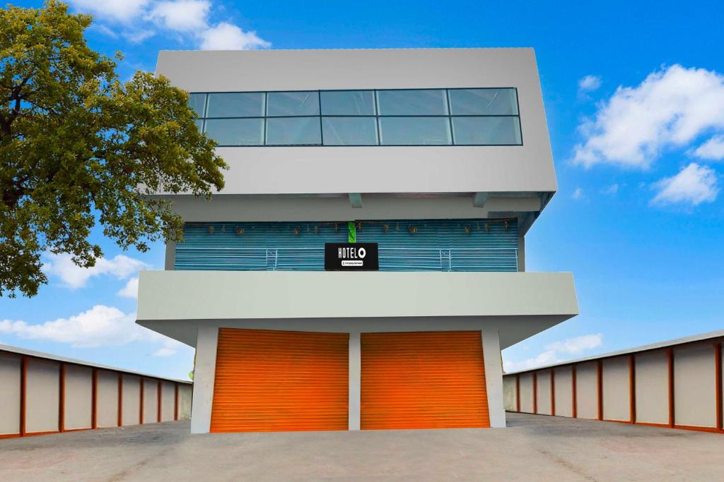 a building with orange doors and a sign on it at Townhouse Warangal Central Station in Warangal
