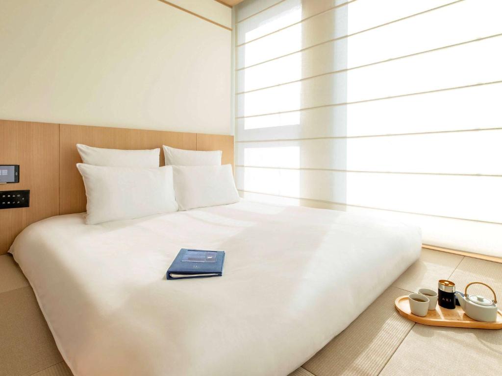 Letto o letti in una camera di AKI Hong Kong - MGallery