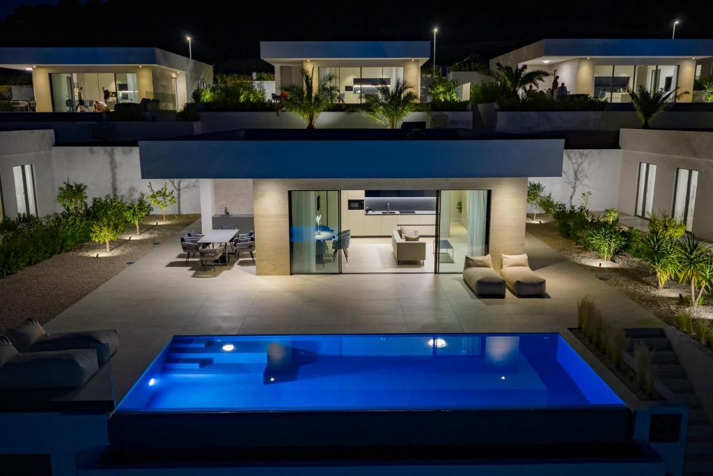 a house with a swimming pool at night at Cloud 9 D2 in Tkon