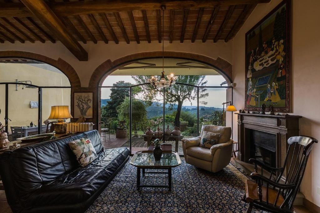 a living room with a couch and a fireplace at Florence Countryside Giogoli a place to be in Scandicci