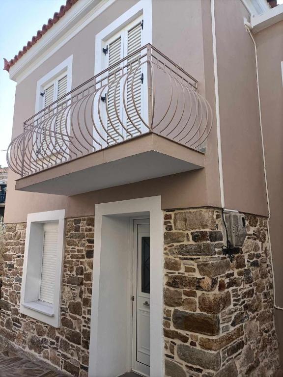 a balcony on the side of a building at Casa Giulia West Samos Lekka Hills Karlovasi 3BR Village Home in Samos