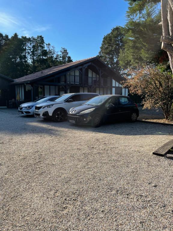 a group of cars parked in front of a house at OSTAL 158 in Le Barp