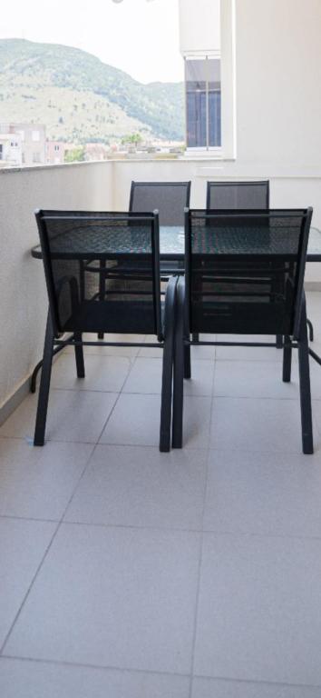 two black benches sitting on top of a building at Delux in Trebinje