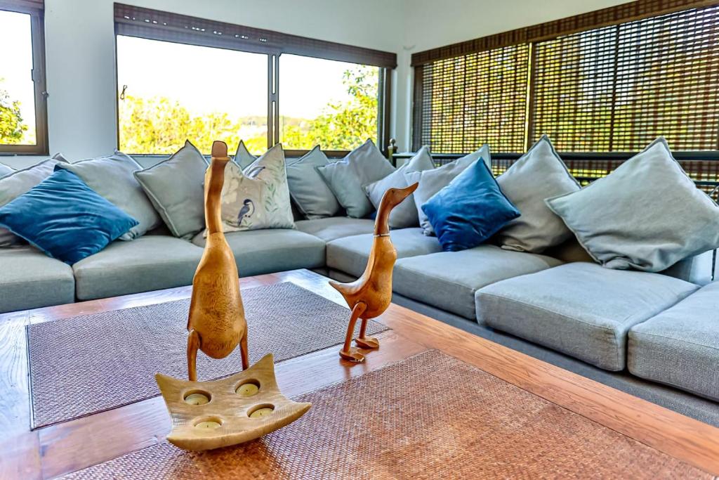 twoanimal statues in a living room with a couch at RR001 Robbins Road - A home away from home in Ballito